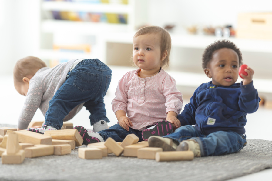 Three infants playing